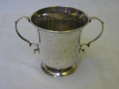 Appraisal: A GEORGE II LOVING CUP with moulded rim double scroll