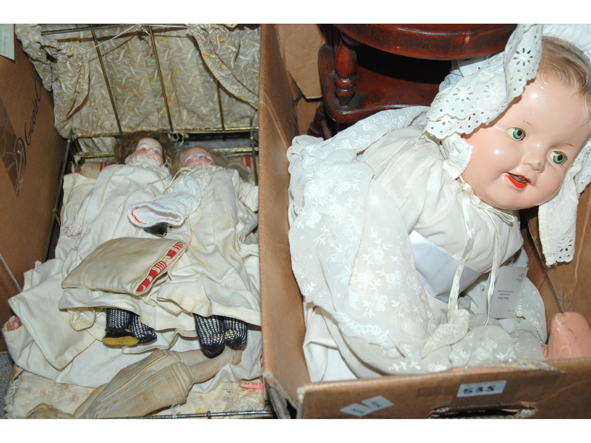 Appraisal: A collection of various dolls and metal-framed doll's bed and