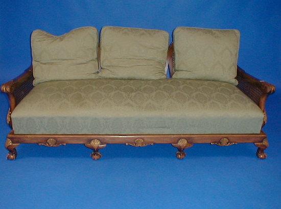 Appraisal: A carved walnut bergere three seater sofa with double caned