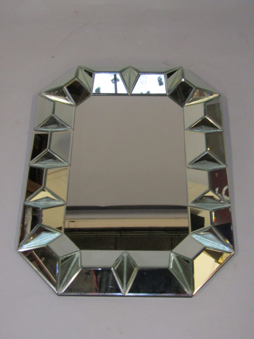 Appraisal: A rectangular glass wall mirror with a faceted glass border