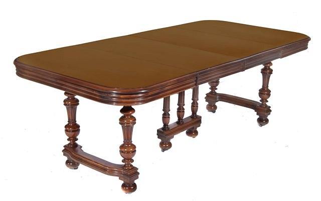 Appraisal: A FRENCH WALNUT EXTENDING DINING TABLE the top with a