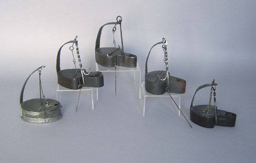 Appraisal: Four iron betty lamps together with a tin example Provenance