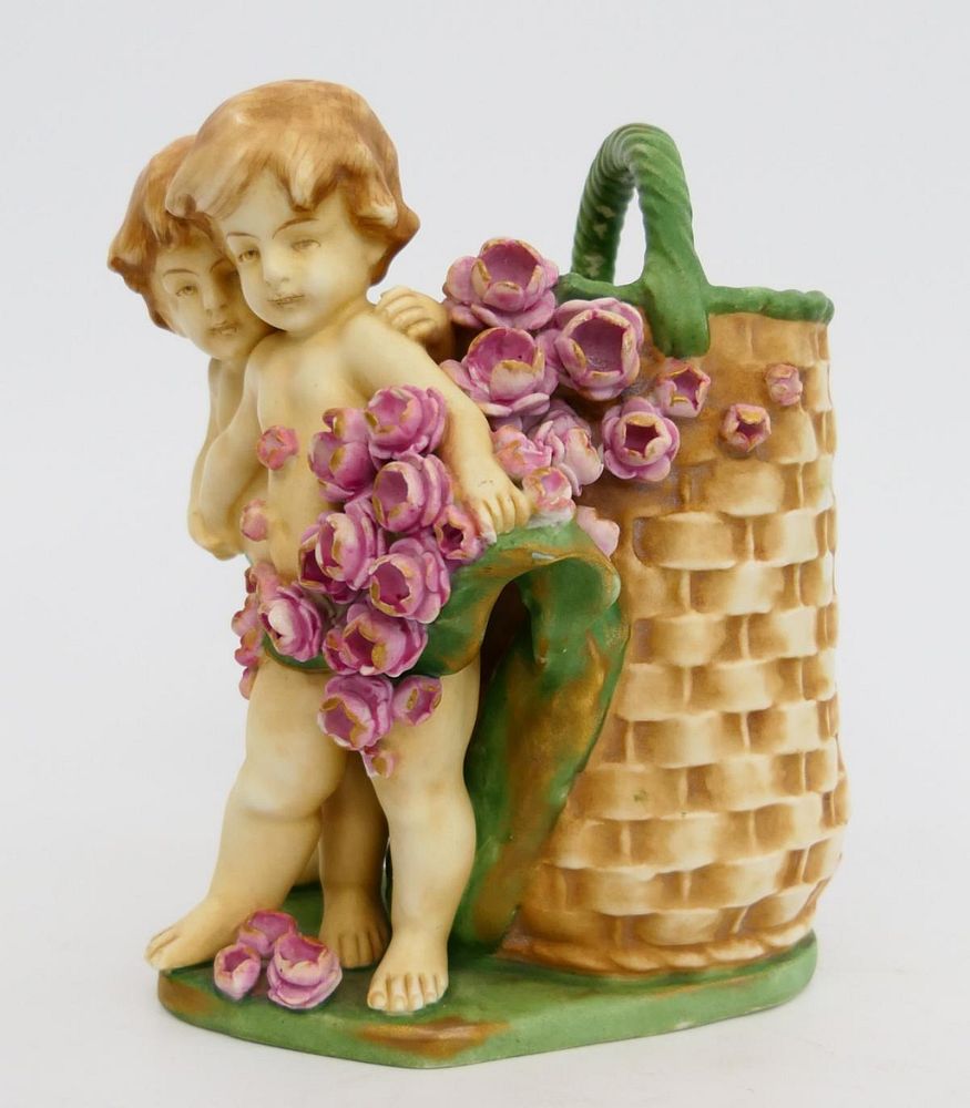 Appraisal: AUSTRIAN PORCELAIN CHERUB VASE AUSTRIAN PORCELAIN CHERUB VASE measures height