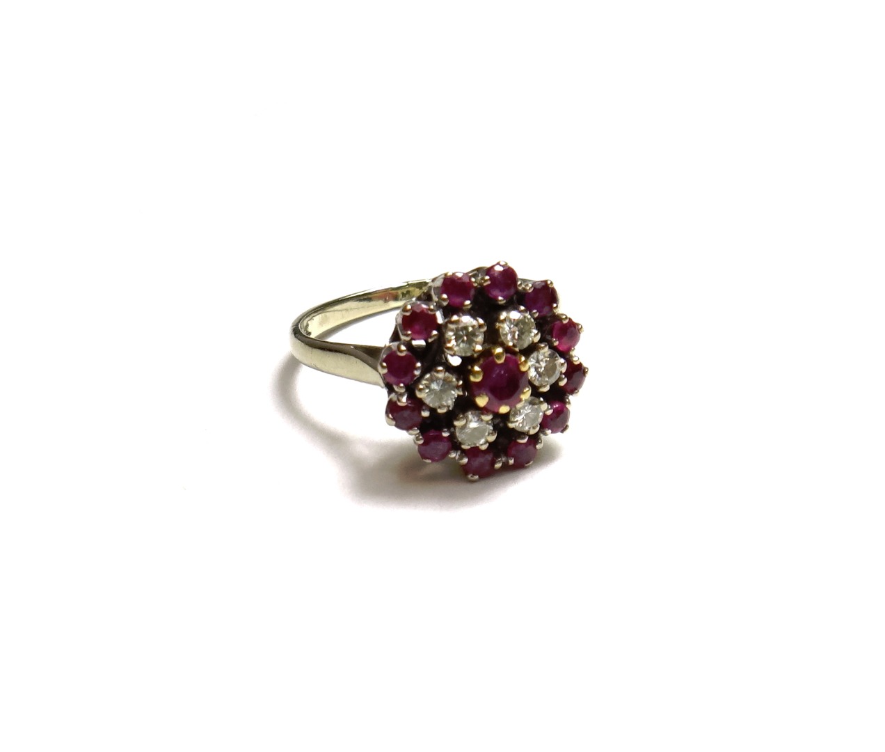 Appraisal: A white gold ruby and diamond set cluster ring claw