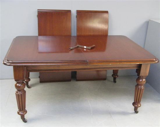 Appraisal: Victorian mahogany dining table with two extra leaves and winding