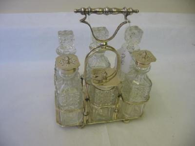 Appraisal: AN EDWARDIAN CRUET SET comprising six squared cut glass bottles