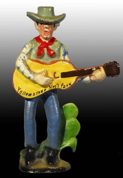 Appraisal: Cast Iron Cowboy with Guitar Bottle Opener Description Made by