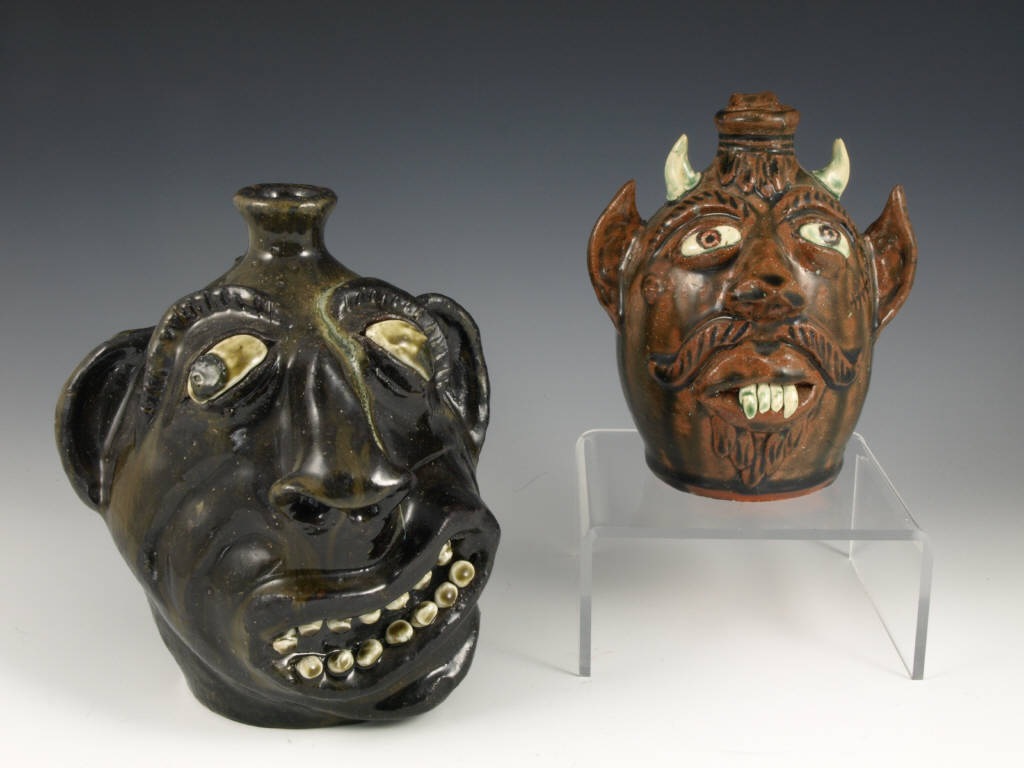 Appraisal: NC Folk Pottery Albert Hodge Two Face Jugs the first