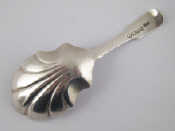 Appraisal: A Georgian silver shell bowl caddy spoon by William Woodman