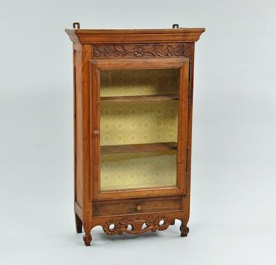 Appraisal: A Provincial French Display Cabinet With a foliate carved frieze