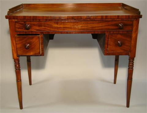 Appraisal: REGENCY MAHOGANY DRESSING TABLE the rectangular top with three-quarter gallery