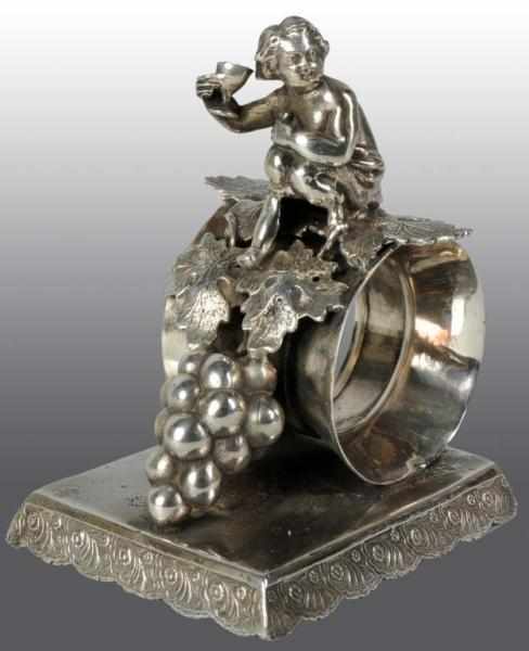 Appraisal: Cherub with Wind Glass atop Napkin Holder Description On rectangular