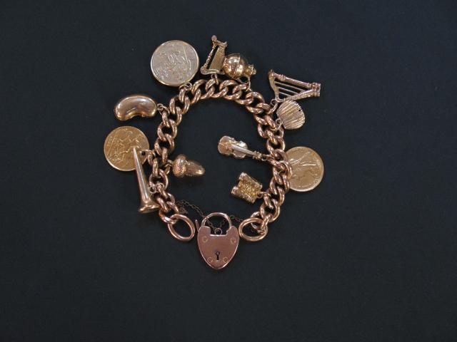 Appraisal: A CT YELLOW GOLD CURB LINK CHARM BRACELET with twelve