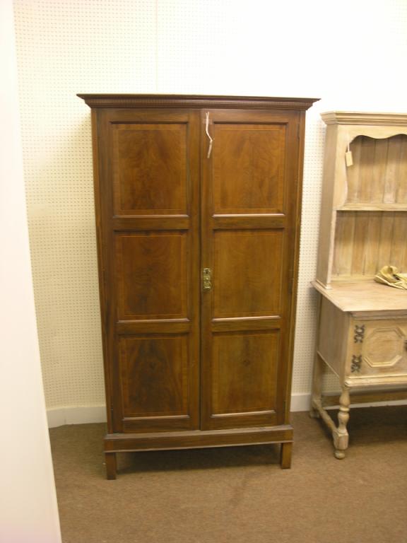 Appraisal: An early th century inlaid mahogany wardrobe enclosed by a