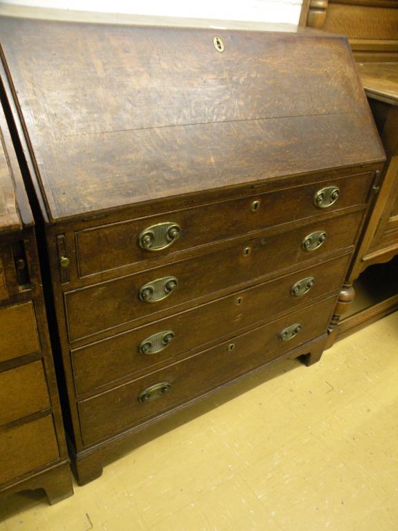 Appraisal: A late thC oak and mahogany cross banded bureau with