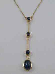 Appraisal: A yellow metal tests carat gold cabochon sapphire pendant necklace