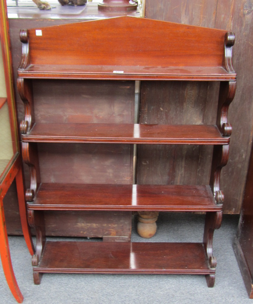 Appraisal: A th century mahogany open hanging four tier wall shelf