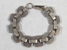 Appraisal: A white metal tests silver geometric design bracelet circa