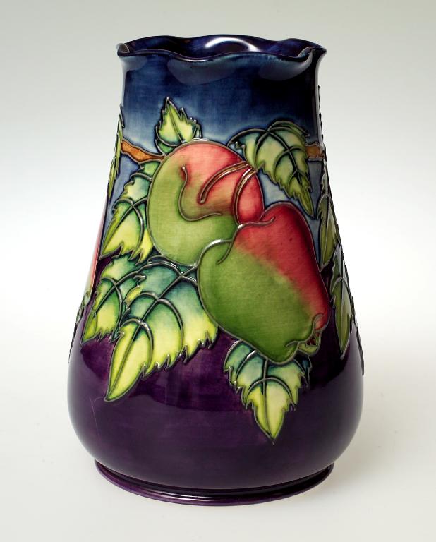 Appraisal: MOORCROFT POTTERY VASE of tapering form with undulating rim tubelined