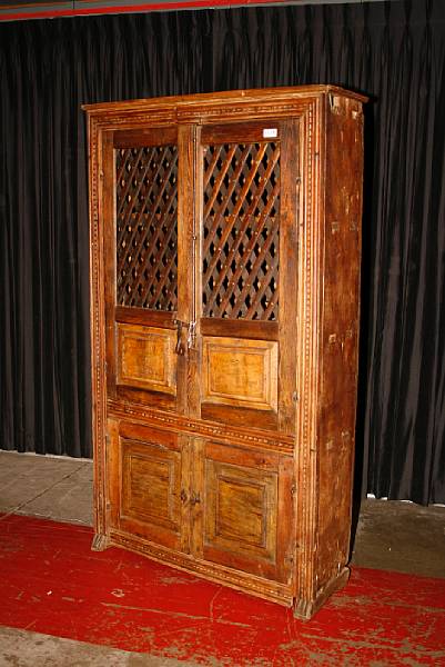 Appraisal: A Spanish Colonial carved pine cupboard lacking one shoe foot