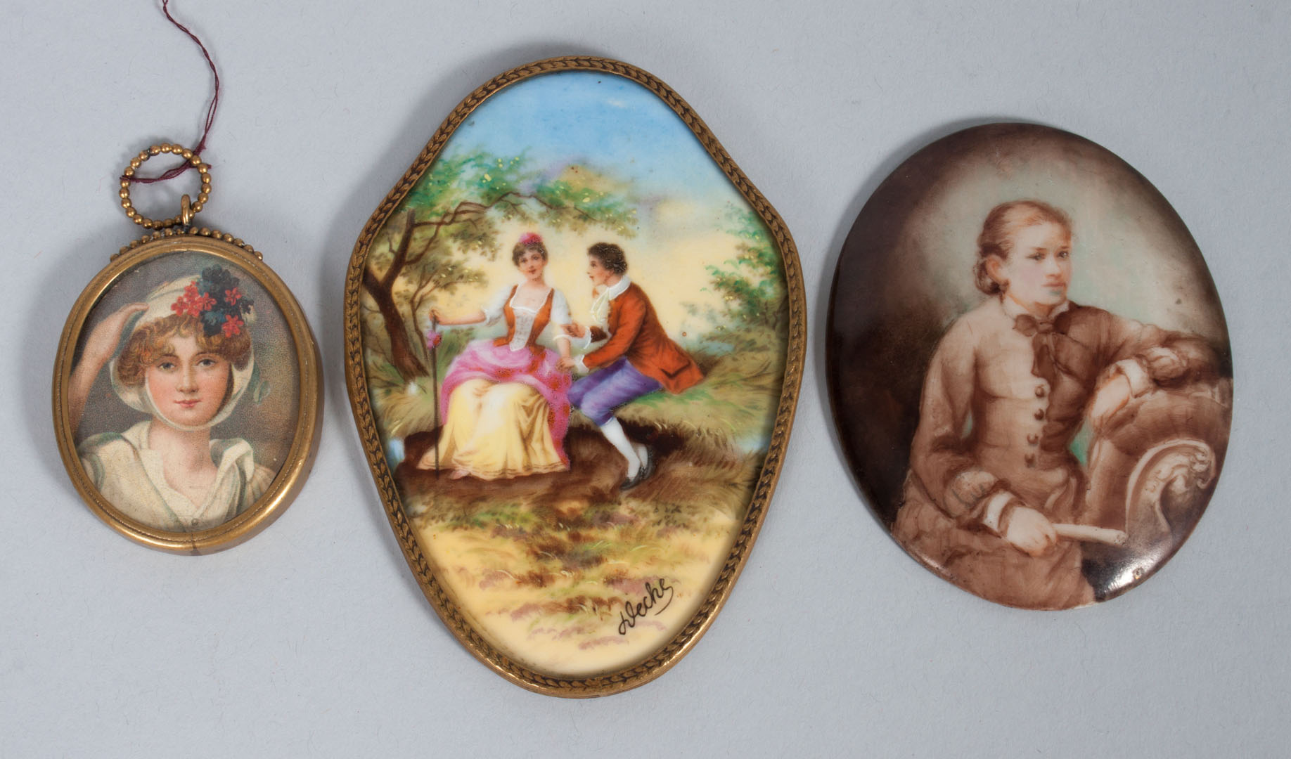 Appraisal: Two porcelain plaques miniature portrait gilt-metal frame plaque of young