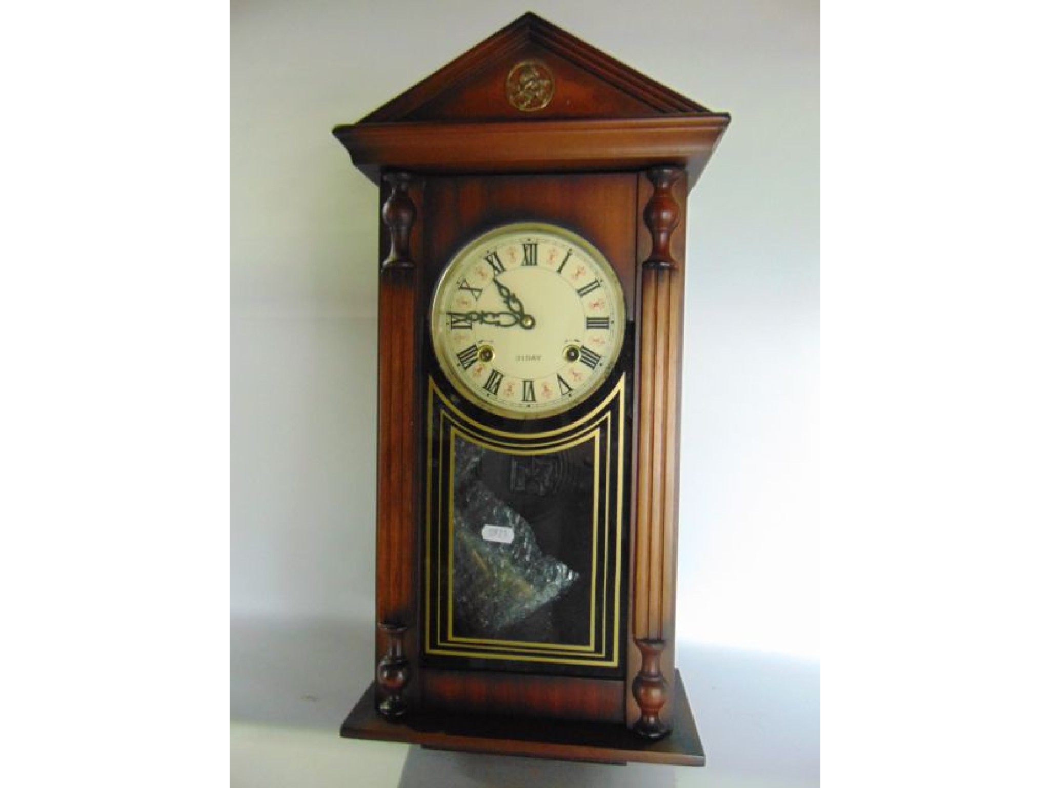 Appraisal: A reproduction wall clock with simulated column supports enclosing a