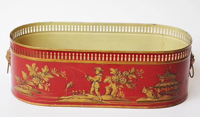 Appraisal: A CONTINENTAL RED PAINTED TOLEWARE JARDINIERE with pierced rim decorated