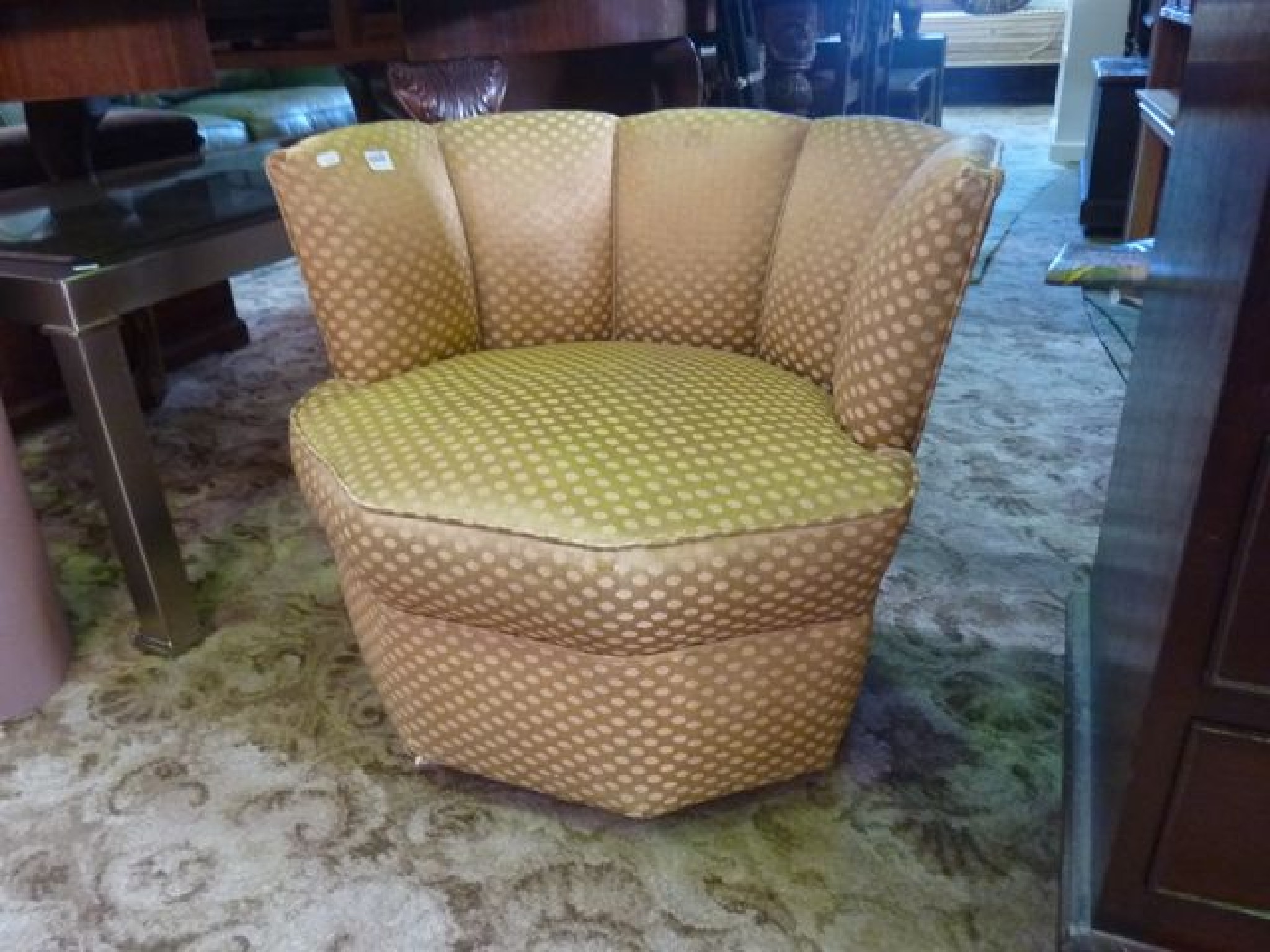 Appraisal: A low upholstered chair with octagonal outline and shallow raised