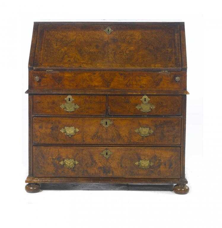 Appraisal: A GEORGE I WALNUT AND FEATHER BANDED BUREAU the flap