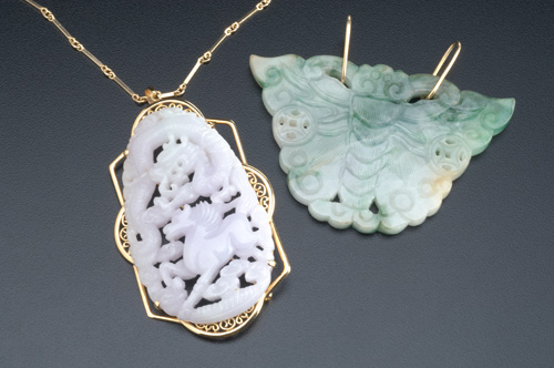 Appraisal: Two large carved jade pendants on k yg mounts with