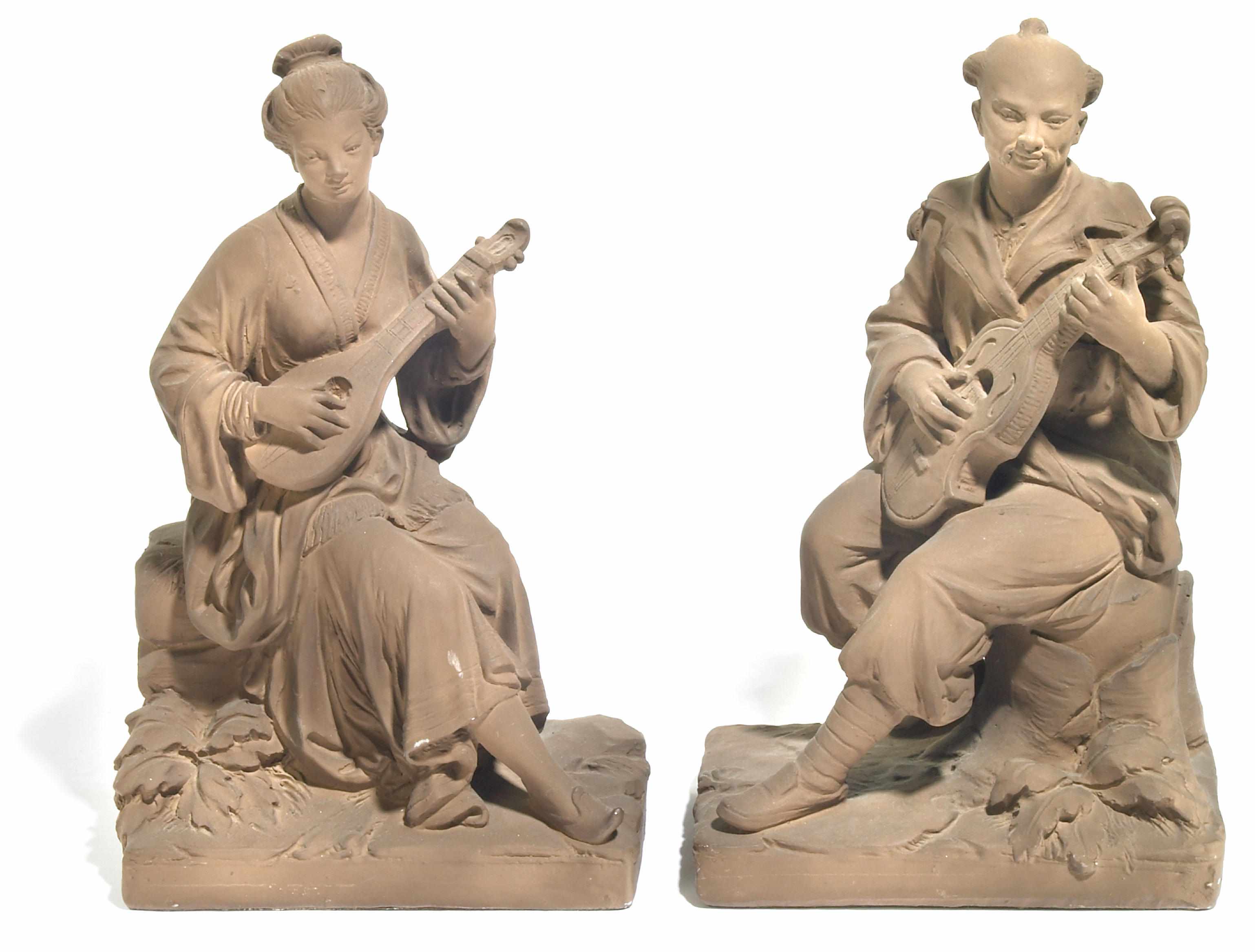 Appraisal: A pair of Continental tinted plaster figures of seated Asian