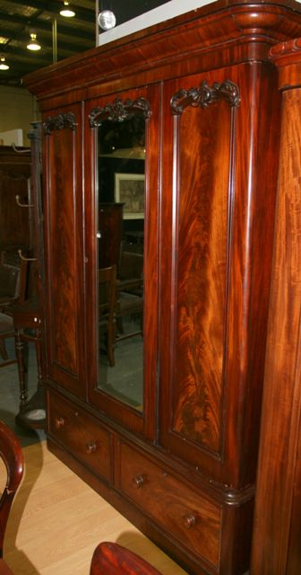 Appraisal: A Victorian mahogany wardrobe with a central mirrored door above