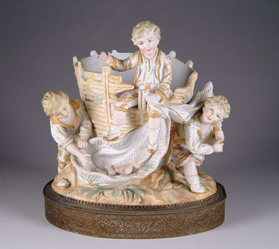 Appraisal: GERMAN FIGURAL LAMP BASE Features three molded painted bisque boys