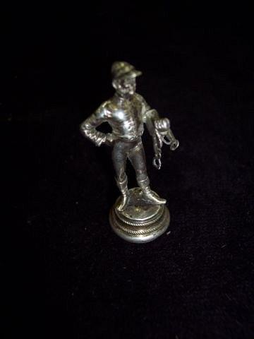 Appraisal: An Austrian desk seal modelled as a standing jockey with