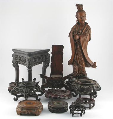 Appraisal: A Chinese hardwood caving of Guanyin standing on a lotus