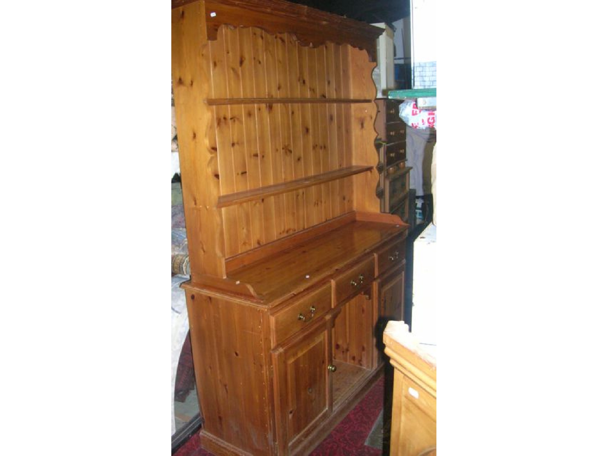 Appraisal: A contemporary stripped pine kitchen dresser the base partially enclosed