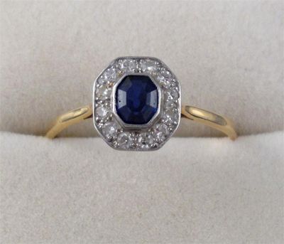 Appraisal: A sapphire and diamond cluster ring The octagonal cut sapphire