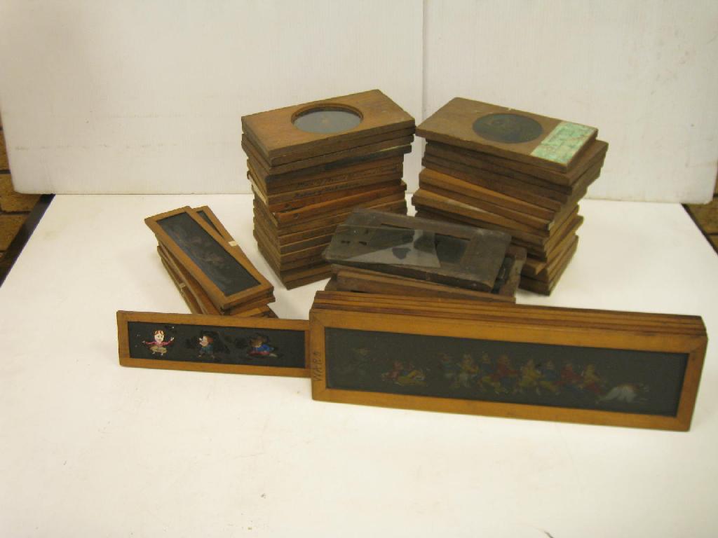 Appraisal: A collection of coloured mahogany framed Lantern Slides