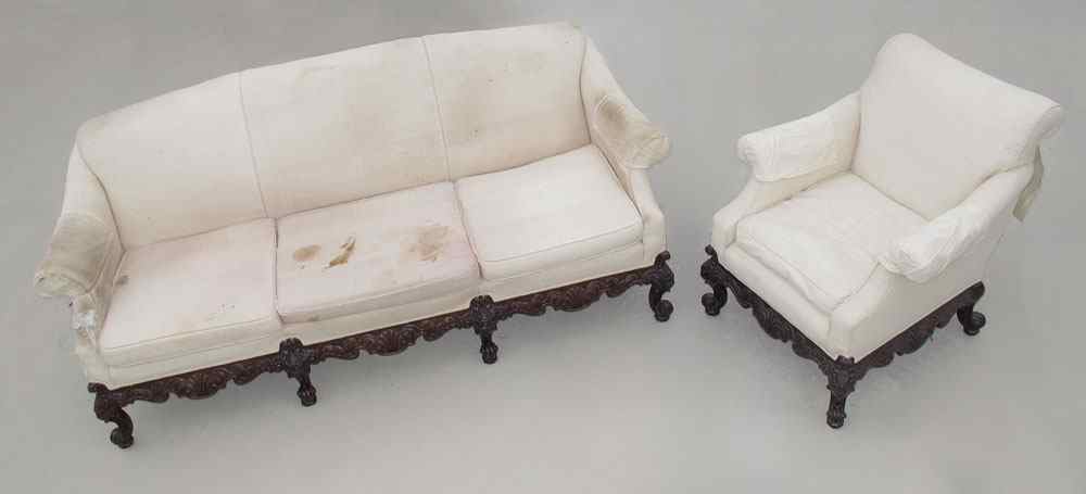 Appraisal: SUPERBLY CARVED MAHOGANY SOFA AND CLUB CHAIR Carved skirt and