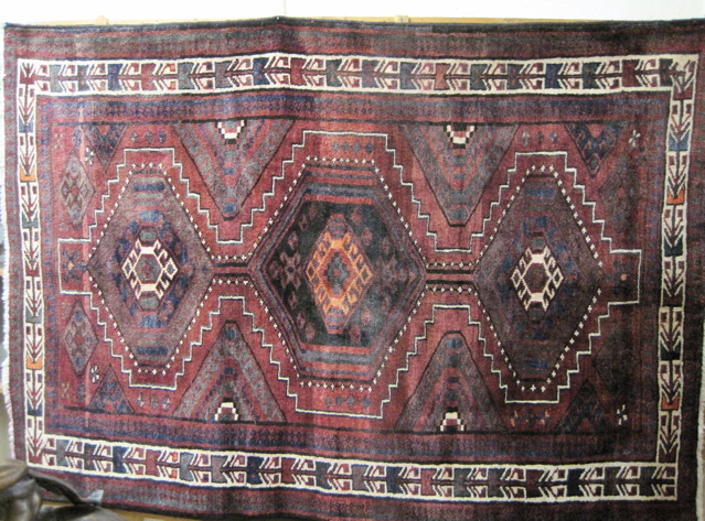 Appraisal: PERSIAN BELOUCHI TRIBAL AREA RUG three geometric medallion design on