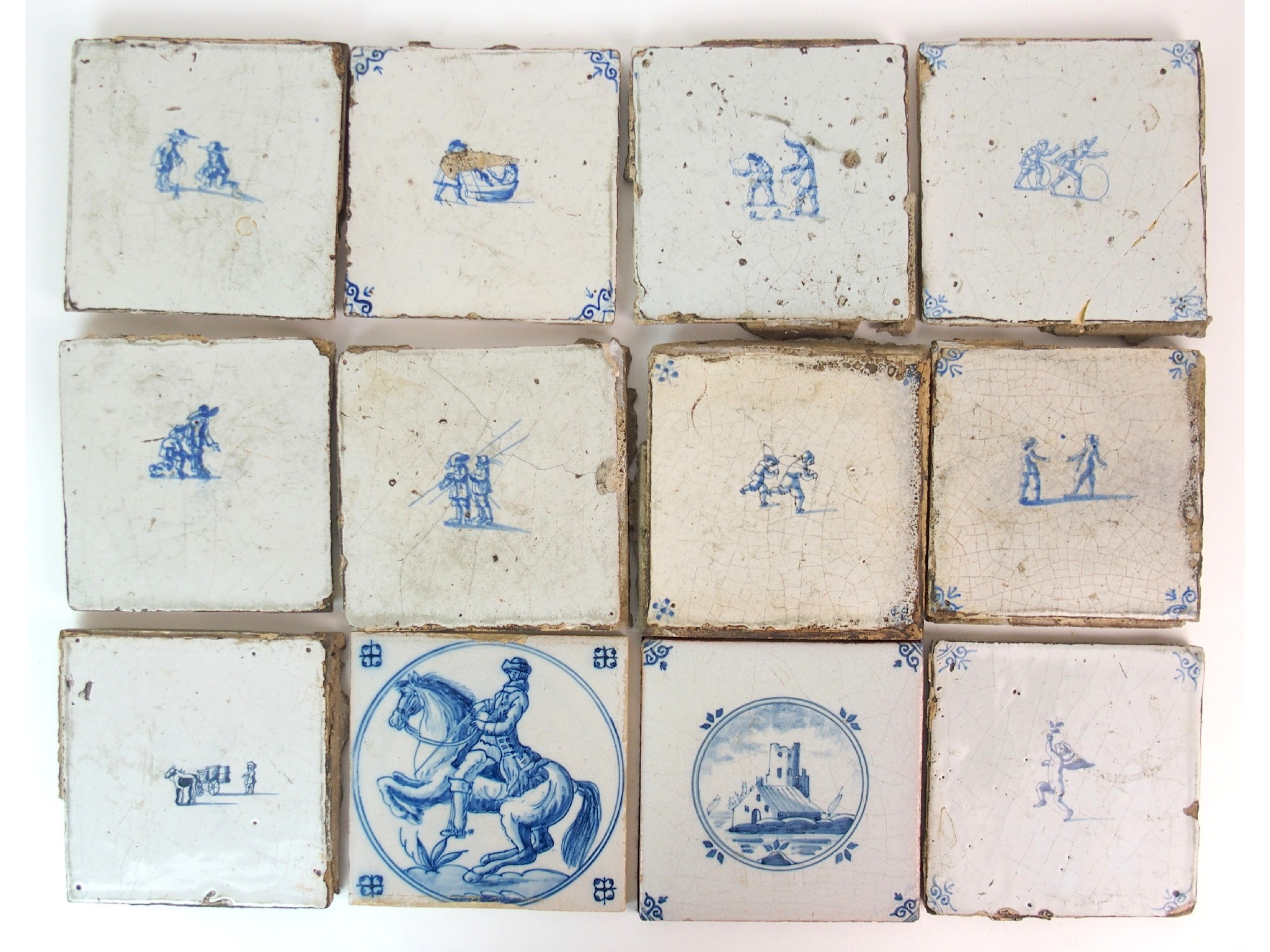 Appraisal: Twelve various Delft blue and white tilespainted with figures at