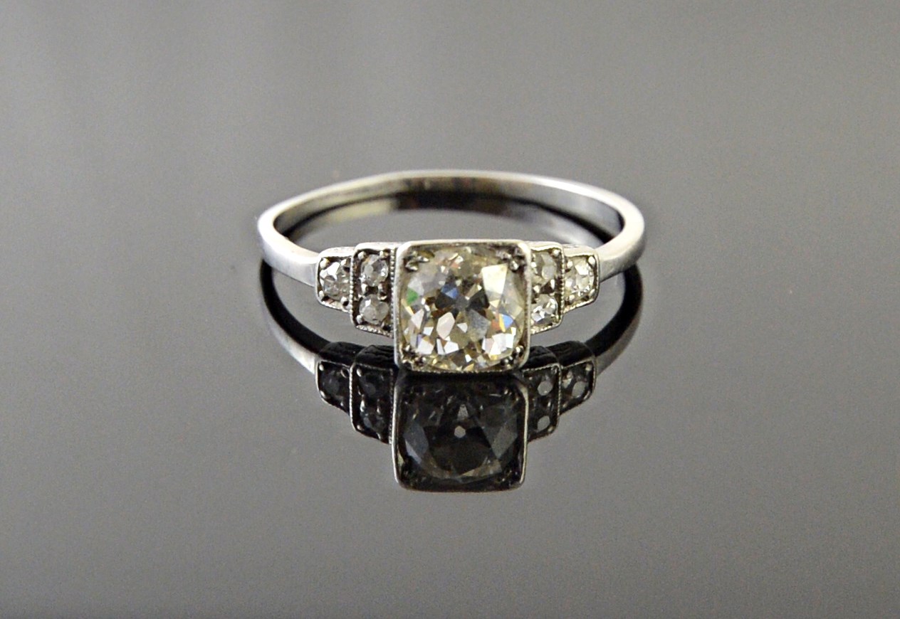 Appraisal: A diamond ring mounted with the principal cushion shaped diamond