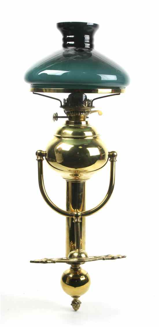 Appraisal: A Brass Ship's Fluid Sconce having a shaped backplate with