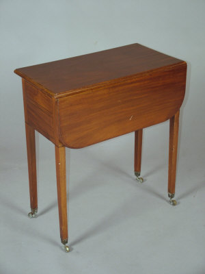 Appraisal: An Edwardian mahogany side table the moulded top above fall