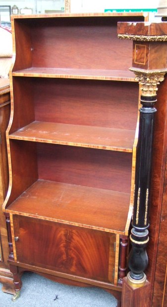 Appraisal: A mahogany and Kingwood banded waterfall bookcase with a cupboard