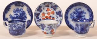 Appraisal: Three Flow Blue Ironstone China Cups Saucers Three Flow Blue