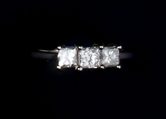 Appraisal: A DIAMOND THREE STONE RING claw set with princess-cut diamonds