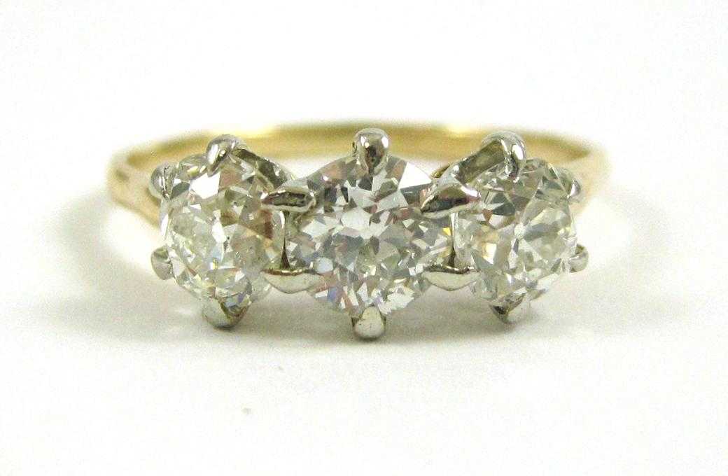 Appraisal: THREE-STONE DIAMOND AND FOURTEEN KARAT GOLD RING The two tone