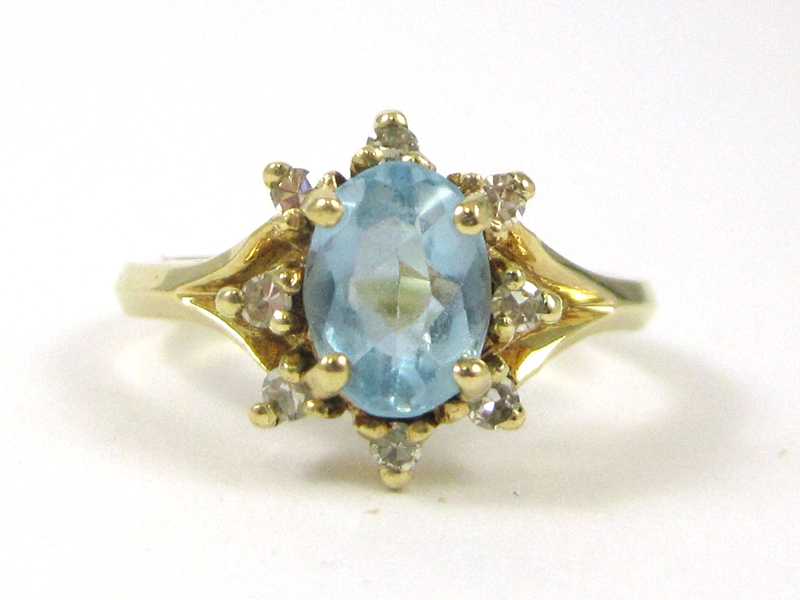 Appraisal: BLUE TOPAZ AND FOURTEEN KARAT GOLD RING with eight round-cut