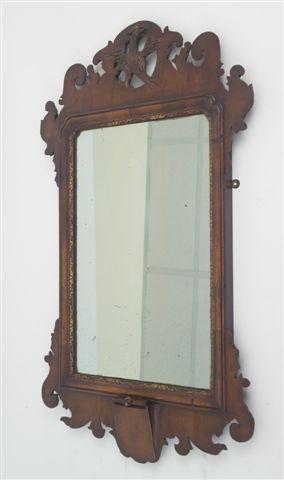 Appraisal: GEORGE III STYLE WALNUT PARCEL-GILT FRETWORK MIRROR the crest carved